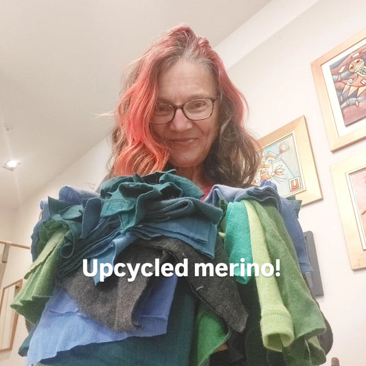 Heke Design upcycling expert Bea Lorimer holding up swatches of merino fabric