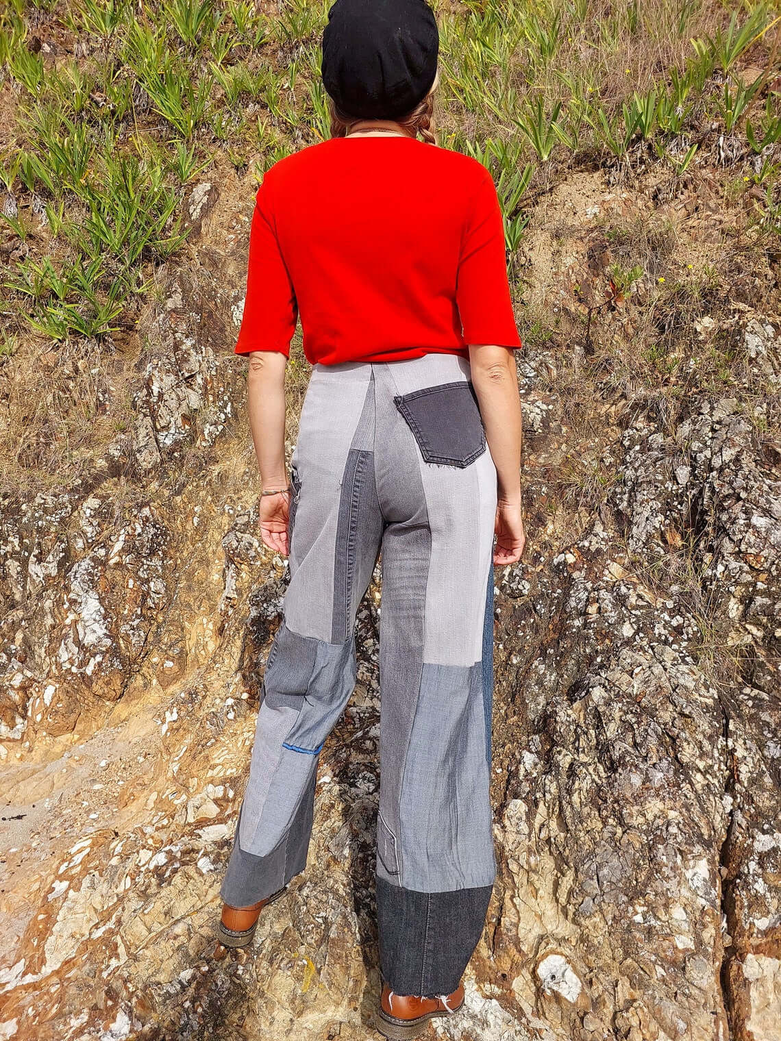 Customer displaying the unique patchwork design of Heke Design’s upcycled jeans