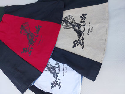Upcycled denim A-line skirt featuring a hand-screenprinted NZ fantail motif on the front panel.