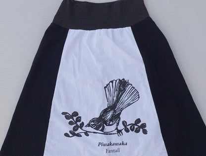 Artisanal detail of the Heke Design screenprinting process on upcycled white fabric, showcasing the 'one of one' nature of our Waiheke-made garments.
