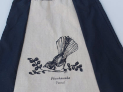 Artisanal detail of the Heke Design screenprinting process on upcycled navy fabric, showcasing the 'one of one' nature of our Waiheke-made garments.