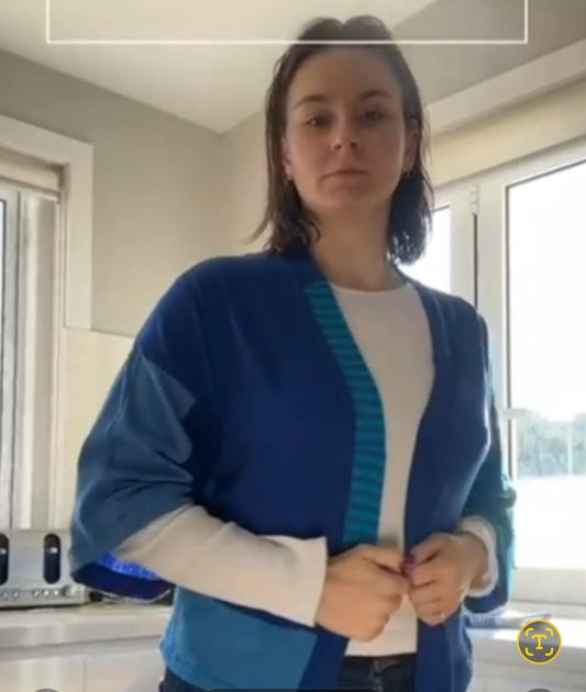 Person wearing a blue cardigan in a kitchen setting with text 'Or Blue?' displayed.